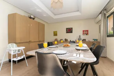 a dining room with a table and chairs at Villa centre Marrakech piscine sans vis-à-vis et Jacuzzi in Marrakech