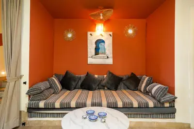 a living room with a couch and a table at Villa centre Marrakech piscine sans vis-à-vis et Jacuzzi in Marrakech