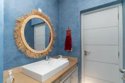a bathroom with a white sink and a mirror at Villa centre Marrakech piscine sans vis-à-vis et Jacuzzi in Marrakech