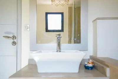 a bathroom with a white sink and a mirror at Villa centre Marrakech piscine sans vis-à-vis et Jacuzzi in Marrakech