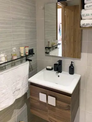 a bathroom with a white sink and a mirror at Nejma House - 1 BR with pool in Marrakech