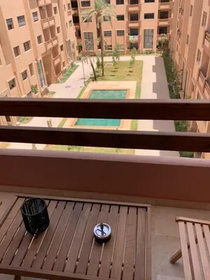 a bowl sitting on a wooden bench on a balcony at Nejma House - 1 BR with pool in Marrakech