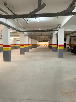 an empty parking garage with columns and cars in it at Nejma House - 1 BR with pool in Marrakech