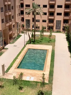 an empty swimming pool in front of a building at Nejma House - 1 BR with pool in Marrakech