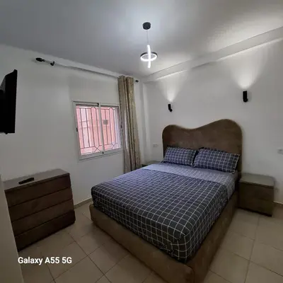 a bedroom with a bed and a television in it at Douira in Marrakech