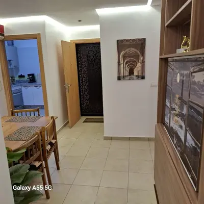 a dining room with a table and a door at Douira in Marrakech