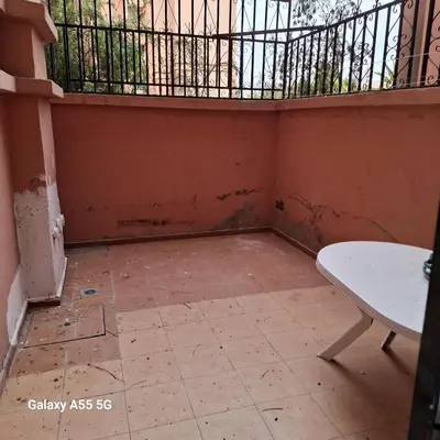 an empty room with a table and a balcony at Douira in Marrakech