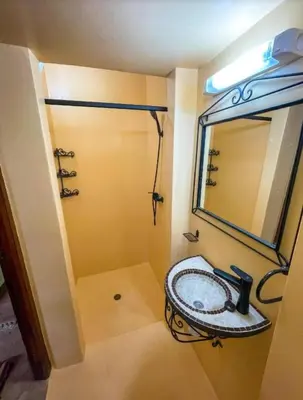 a bathroom with a sink and a mirror at FERME D'HOTES BARGHALi in Marrakech