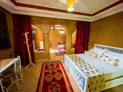 a bedroom with a large bed in a room at FERME D'HOTES BARGHALi in Marrakech