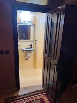 a bathroom with a sink and a mirror at FERME D'HOTES BARGHALi in Marrakech