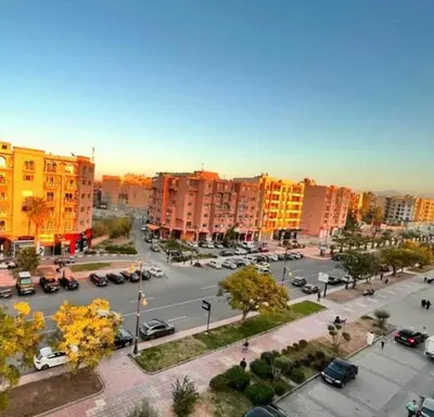 a city with cars parked in a parking lot at Gone app Marrakech in Marrakech