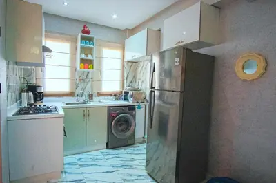 a kitchen with a refrigerator and a washing machine at Gone app Marrakech in Marrakech