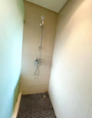 a shower in a bathroom with a black and white tile floor at Nice Villa Prestigia golf city marrakech in Marrakech