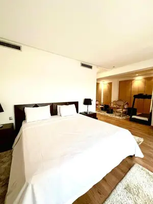 a bedroom with a large bed with white sheets at Nice Villa Prestigia golf city marrakech in Marrakech