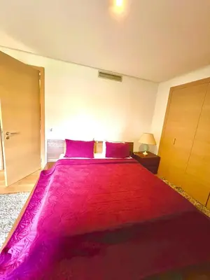 a bedroom with a large bed with a red blanket at Nice Villa Prestigia golf city marrakech in Marrakech
