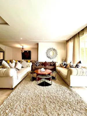 a large living room with couches and a table at Nice Villa Prestigia golf city marrakech in Marrakech