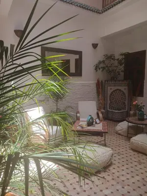 a living room with a couch and a table at Riad Dantella in Marrakech