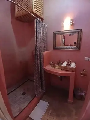 a bathroom with a sink and a mirror at Riad Dantella in Marrakech