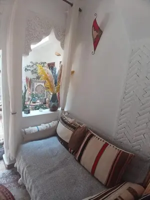 a room with a couch with pillows on it at Riad Dantella in Marrakech