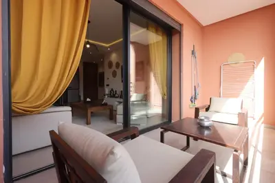 a living room with a couch and a table at Modern top floor apartment with balcony! in Marrakech