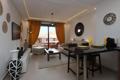 a living room with a table and a couch at Modern top floor apartment with balcony! in Marrakech