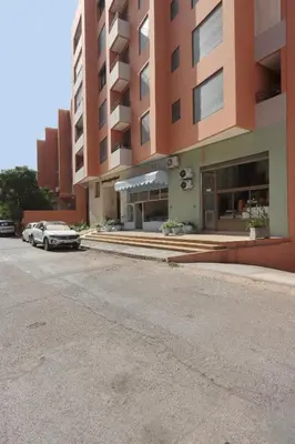 a car parked in front of a building at Modern top floor apartment with balcony! in Marrakech
