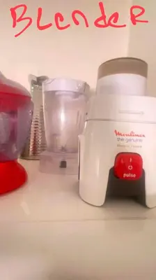 a white blender sitting on top of a counter at RED YACOUT Parking Sécurisé in Marrakech