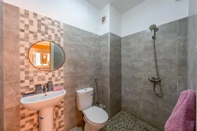 a bathroom with a toilet and a sink and a mirror at RED YACOUT Parking Sécurisé in Marrakech