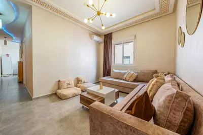 a living room with a couch and a table at RED YACOUT Parking Sécurisé in Marrakech