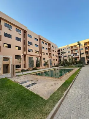 an apartment building with a swimming pool in front of it at Stylish Escape Modern Comforts in Marrakech