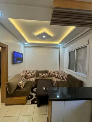 a living room with a couch and a tv at Piso en Marrakech in Marrakech