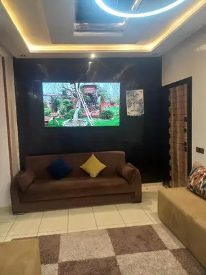 a living room with a couch and a flat screen tv at Piso en Marrakech in Marrakech