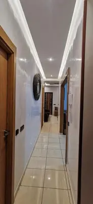 a hallway with a white ceiling and a tile floor at Piso en Marrakech in Marrakech