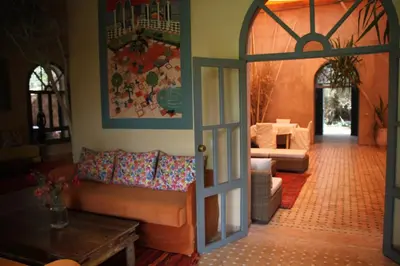 an open door into a living room with a couch at villa hibiscus marrakech in Marrakech