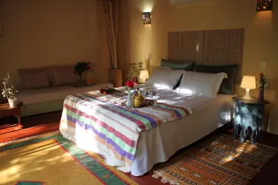 a bedroom with a large bed and a couch at villa hibiscus marrakech in Marrakech