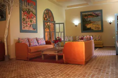 a living room with two couches and a table at villa hibiscus marrakech in Marrakech