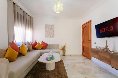 a living room with a couch and a table at Refuge Peachy Guéliz et Confort in Marrakech