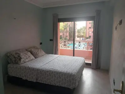 a bedroom with a bed and a large window at Chic 2BR Apartment with Beautiful Moroccan Salon in Marrakech