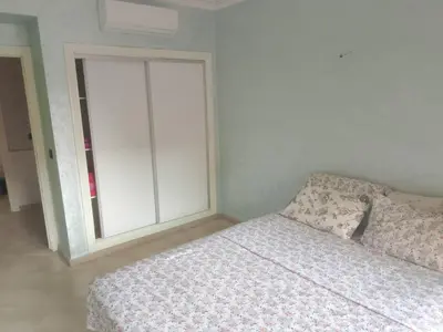 a bedroom with a bed and a window at Chic 2BR Apartment with Beautiful Moroccan Salon in Marrakech