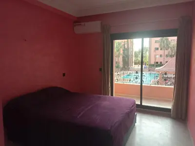 a bedroom with a bed and a large window at Chic 2BR Apartment with Beautiful Moroccan Salon in Marrakech