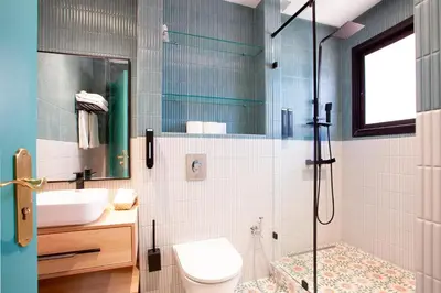 a bathroom with a shower and a toilet and a sink at Triplex luxe marrakech in Marrakech