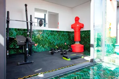 a room with a swimming pool and a gym at Triplex luxe marrakech in Marrakech