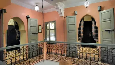 a room with two doors and a balcony at Riad Bouchra, riad privatif proche de la place Jemaa-El-Fna in Marrakech