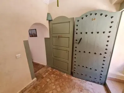 a room with a closet with a door and a shelf at Riad Bouchra, riad privatif proche de la place Jemaa-El-Fna in Marrakech