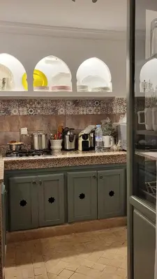 a kitchen with a counter with pots and pans at Riad Bouchra, riad privatif proche de la place Jemaa-El-Fna in Marrakech