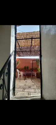 an open door to a patio with a table and chairs at Riad 05 in Marrakech