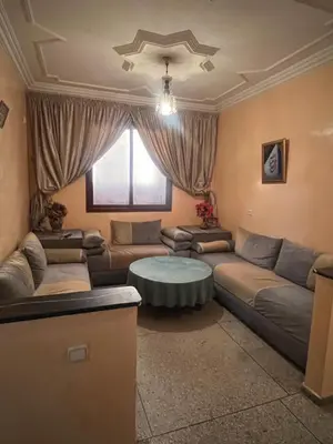 a living room with a couch and a table at dar shahd in Marrakech