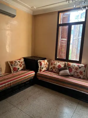 a room with two couches in a room with two windows at dar shahd in Marrakech