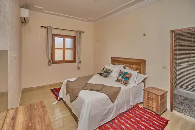 a bedroom with a bed and a window at Dar Hma in Marrakech