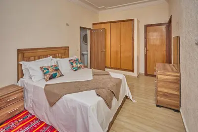 a bedroom with a bed with white sheets and pillows at Dar Hma in Marrakech
